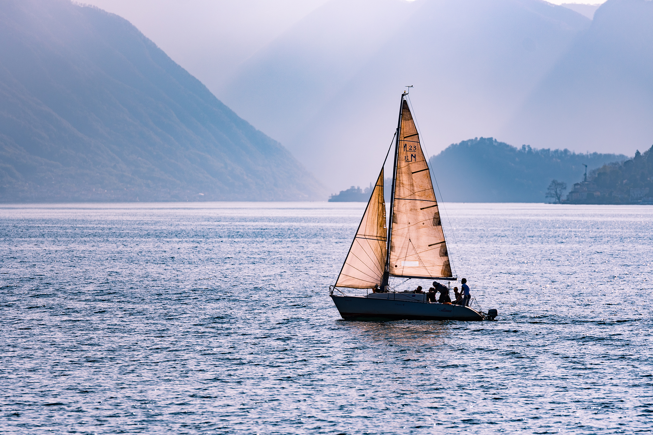 Sailboat on the ocean with mountains